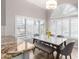 Dining area with a marble table, a bench, four chairs, and many bright windows with plantation shutters at 15215 S 20Th Pl, Phoenix, AZ 85048