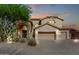 Stunning two-story home featuring a three-car garage, desert landscaping, and beautiful sunset colors at 15215 S 20Th Pl, Phoenix, AZ 85048