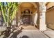Elegant entrance showcasing a covered porch with desert foliage and an oversized front door at 15215 S 20Th Pl, Phoenix, AZ 85048