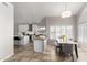 Spacious kitchen with an island, stainless steel appliances, granite countertops, and an adjacent dining area at 15215 S 20Th Pl, Phoenix, AZ 85048