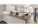 Modern kitchen with stainless steel appliances, large island, granite countertops, and white cabinetry at 15215 S 20Th Pl, Phoenix, AZ 85048