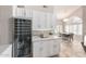 Kitchen area featuring custom cabinetry, sleek countertops, wine fridge and an open view to dining area at 15215 S 20Th Pl, Phoenix, AZ 85048