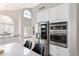 Bright, open kitchen featuring stainless steel appliances, white cabinetry, and a eat-in island at 15215 S 20Th Pl, Phoenix, AZ 85048