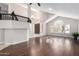 Elegant living room with hardwood floors, high ceilings, large windows, and an open view of the foyer at 15215 S 20Th Pl, Phoenix, AZ 85048
