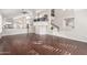 Spacious living room with rich hardwood floors, staircase and an open floor plan showcasing modern architectural details at 15215 S 20Th Pl, Phoenix, AZ 85048