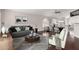 Cozy living room with modern furniture, hardwood floors, and an open layout with dining area and kitchen at 15215 S 20Th Pl, Phoenix, AZ 85048