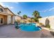 Private backyard featuring a sparkling blue pool, desert foliage and privacy walls at 15215 S 20Th Pl, Phoenix, AZ 85048