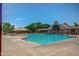 Community pool with a large lounge area, cabana, and expansive concrete deck, perfect for relaxation and recreation at 15215 S 20Th Pl, Phoenix, AZ 85048