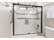 Modern bathroom featuring tiled shower with black frame glass doors and chrome hardware at 15215 S 20Th Pl, Phoenix, AZ 85048