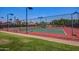 Community tennis court with a meticulously maintained surface, new nets, and surrounding fence, perfect for tennis enthusiasts at 15215 S 20Th Pl, Phoenix, AZ 85048