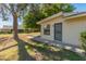 Backyard featuring a private entrance with metal security door and mature landscaping at 15610 N 98Th Ave # 26, Sun City, AZ 85351