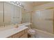 Bathroom featuring a single sink vanity, glass block window, shower over tub at 15610 N 98Th Ave # 26, Sun City, AZ 85351