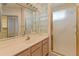 Bathroom featuring a single sink vanity, glass block window, shower and mirrored medicine cabinet at 15610 N 98Th Ave # 26, Sun City, AZ 85351