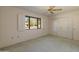 Bedroom with a window, ceiling fan, and closet at 15610 N 98Th Ave # 26, Sun City, AZ 85351