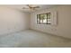 Bedroom with a window, ceiling fan and neutral color palette at 15610 N 98Th Ave # 26, Sun City, AZ 85351