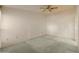 Spacious bedroom features plush carpeting, a ceiling fan, and ample natural light at 15610 N 98Th Ave # 26, Sun City, AZ 85351