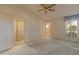 Inviting bedroom with plush carpeting, a ceiling fan, lots of light, and an open floorplan at 15610 N 98Th Ave # 26, Sun City, AZ 85351