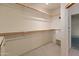 Spacious walk-in closet featuring built in shelving and drawers at 15610 N 98Th Ave # 26, Sun City, AZ 85351