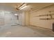 Large garage with ample storage cabinets, workbench and lighting at 15610 N 98Th Ave # 26, Sun City, AZ 85351