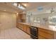 Bright kitchen featuring wood cabinets, tile floors, skylights and modern appliances at 15610 N 98Th Ave # 26, Sun City, AZ 85351