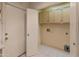 Bright laundry room featuring upper cabinets and utility connections for appliances at 15610 N 98Th Ave # 26, Sun City, AZ 85351