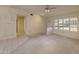 Bright living room featuring carpet flooring, ceiling fans, and large windows at 15610 N 98Th Ave # 26, Sun City, AZ 85351