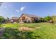 Backyard featuring grass, garden, patio, and home exterior on a sunny day at 16605 W Pierce St, Goodyear, AZ 85338