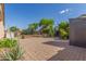 Landscaped backyard with a brick paved patio and fire pit on a sunny day at 16605 W Pierce St, Goodyear, AZ 85338