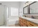 Bathroom with double sinks, granite counters and tiled backsplash, plus a tub and shower at 16605 W Pierce St, Goodyear, AZ 85338