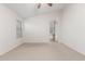 Large bedroom with neutral carpet, plenty of light and an archway to the ensuite bath at 16605 W Pierce St, Goodyear, AZ 85338