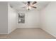 Bedroom with neutral carpet, ceiling fan, and a window for natural light at 16605 W Pierce St, Goodyear, AZ 85338