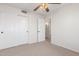 Bedroom with neutral carpet, ceiling fan, and closet space at 16605 W Pierce St, Goodyear, AZ 85338