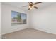Bedroom featuring a ceiling fan and a view from the window at 16605 W Pierce St, Goodyear, AZ 85338