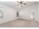 Spacious bedroom with neutral carpet, many windows and an archway leading to a bathroom at 16605 W Pierce St, Goodyear, AZ 85338