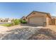 Home exterior with brick walkway, lush bushes, a well-kept lawn, and a two-car garage at 16605 W Pierce St, Goodyear, AZ 85338