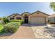 Charming single-story home with a well-manicured front yard, a brick walkway, and a two-car garage at 16605 W Pierce St, Goodyear, AZ 85338