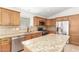 Updated kitchen with granite countertops, stainless steel appliances, and a central island at 16605 W Pierce St, Goodyear, AZ 85338