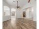 Bright open floor plan featuring wood-look flooring and archways leading to other rooms at 16605 W Pierce St, Goodyear, AZ 85338