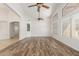 Bright open floor plan featuring wood-look flooring and archways leading to other rooms at 16605 W Pierce St, Goodyear, AZ 85338