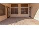Covered patio featuring brick flooring, screens, and an entry to the house at 16605 W Pierce St, Goodyear, AZ 85338