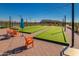 Charming community area featuring bocce ball courts, string lights, and comfortable seating at 17375 W Whispering Wind Rd, Surprise, AZ 85387