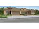 Charming two-story townhome with a brick facade and a two-car garage with a driveway at 17375 W Whispering Wind Rd, Surprise, AZ 85387