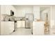 Modern kitchen with stainless steel appliances, white cabinets, and granite countertops with a center island at 17375 W Whispering Wind Rd, Surprise, AZ 85387