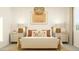 Relaxing primary bedroom with neutral tones, decorative lamps and contemporary artwork at 17375 W Whispering Wind Rd, Surprise, AZ 85387
