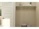 Neutral mudroom with a simple shelf, decorative baskets, and a minimalist design at 17375 W Whispering Wind Rd, Surprise, AZ 85387