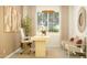 Inviting home office featuring a modern desk, artwork, and comfortable seating area at 17375 W Whispering Wind Rd, Surprise, AZ 85387