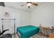 Cozy bedroom with wood laminate floors, a ceiling fan, and a comfortable bed setup at 1770 W Browning Way, Chandler, AZ 85286