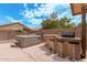 A hot tub sits on the edge of the patio, next to an outdoor bar at 1770 W Browning Way, Chandler, AZ 85286