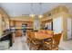 Eat-in kitchen featuring a dining table, kitchen island, stainless appliances, and granite countertops at 1770 W Browning Way, Chandler, AZ 85286