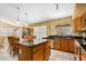 Kitchen island with granite countertop and wood cabinetry. Features stainless steel appliances and lots of light at 1770 W Browning Way, Chandler, AZ 85286